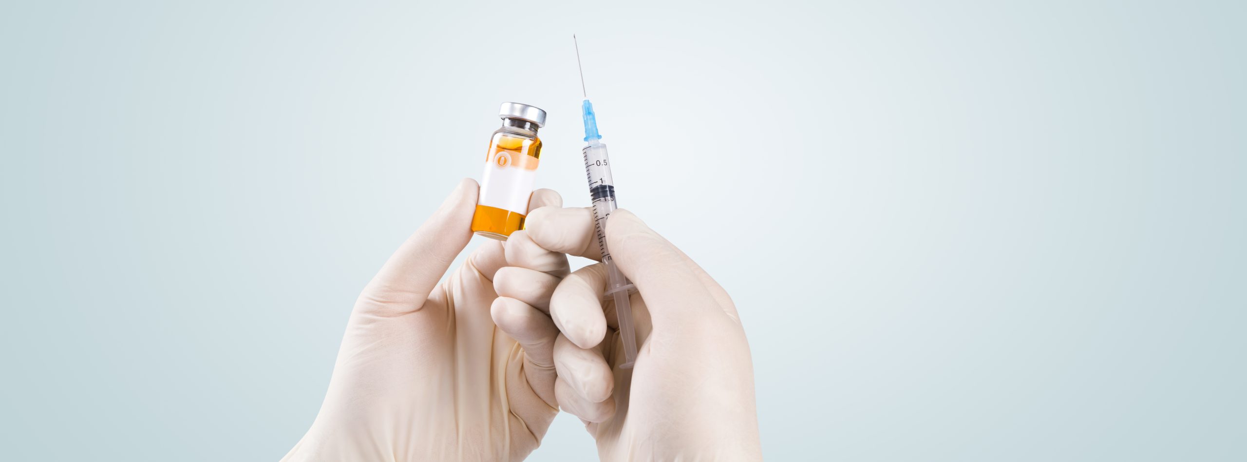 vecteezy hand holding syringe with vaccine against corona virus 6544089 322 scaled
