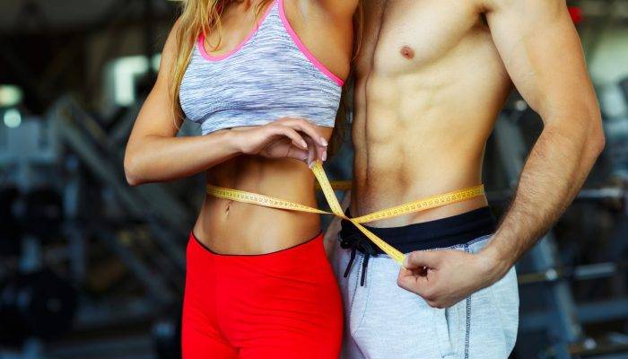 vecteezy_man-and-woman-with-measuring-tape-in-gym_21150043_64-scaled.jpg